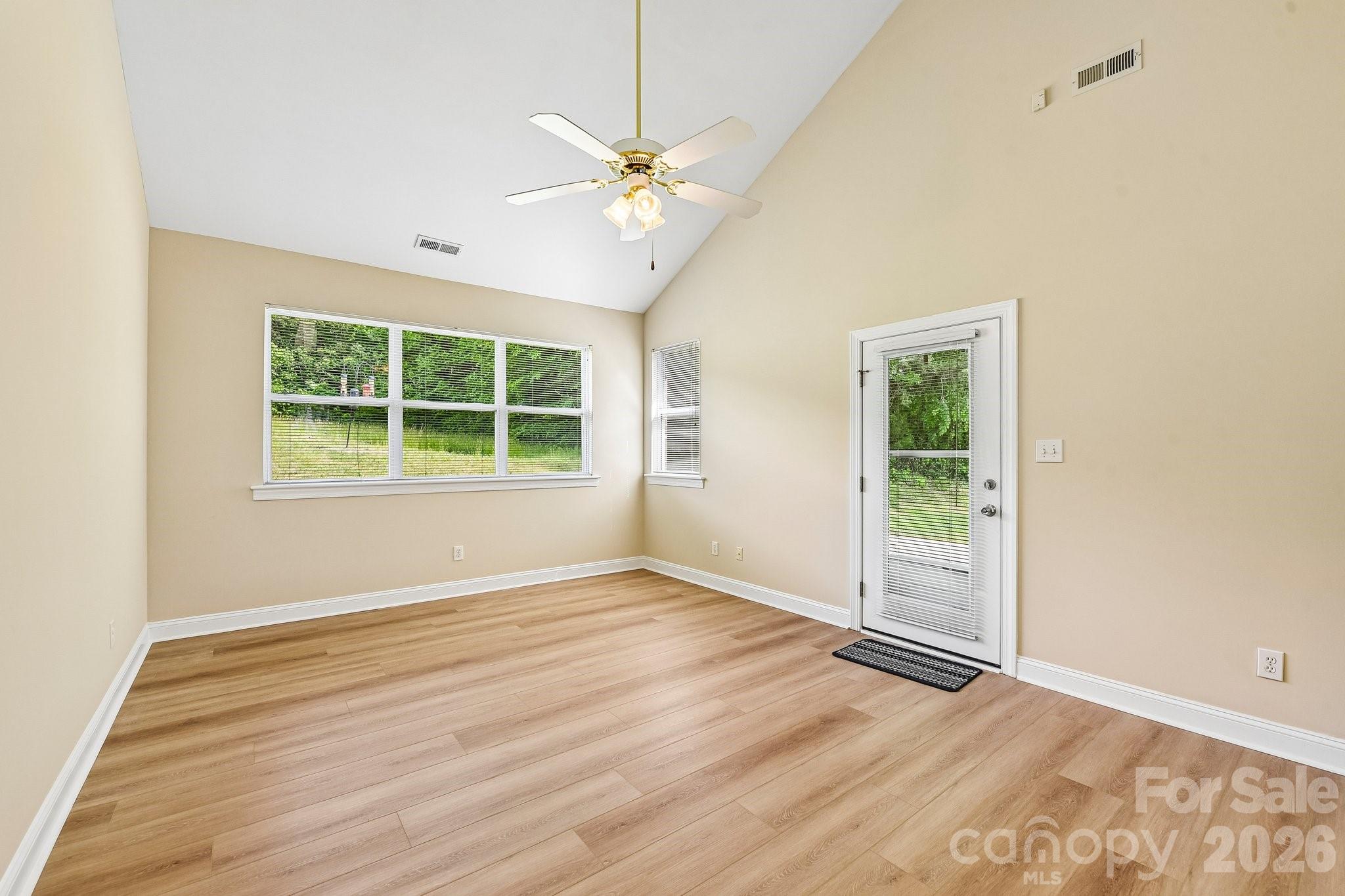 3854 Azalea Trail Denver, NC 28037 - Photo 5 of 22 an empty room with wooden floor and windows