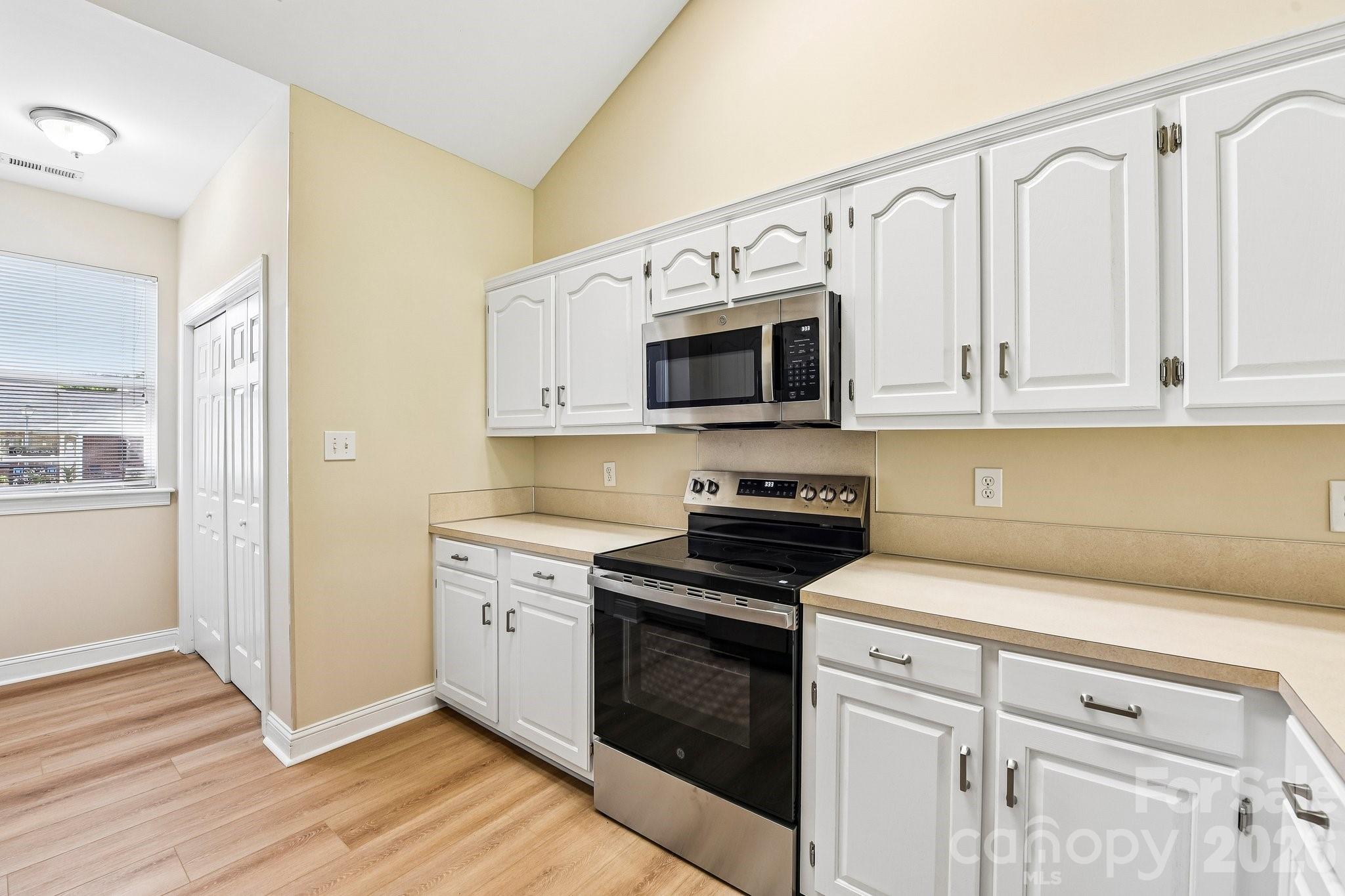 3854 Azalea Trail Denver, NC 28037 - Photo 8 of 22 a kitchen with white cabinets stainless steel appliances and sink