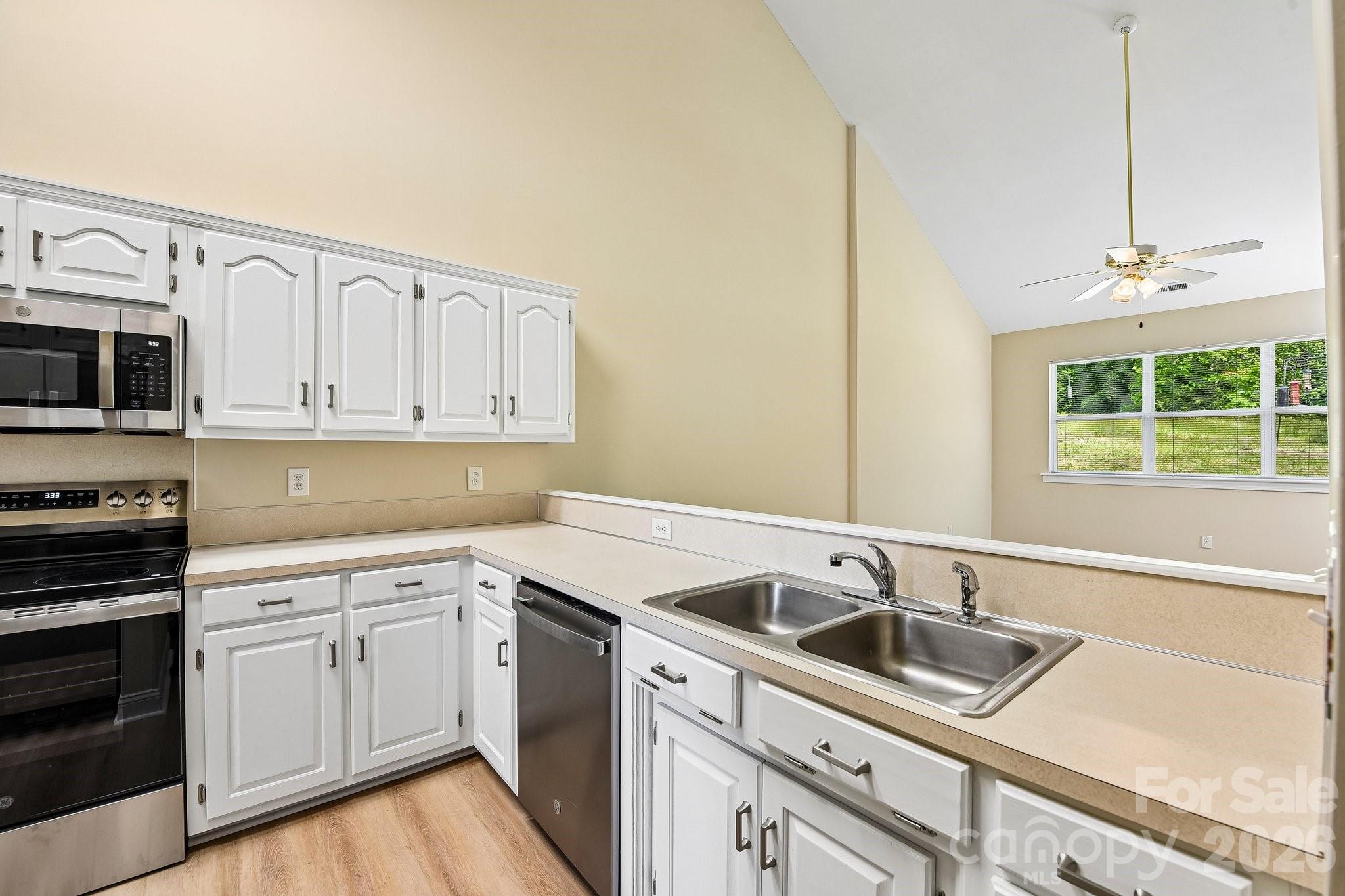 3854 Azalea Trail Denver, NC 28037 - Photo 10 of 22 a kitchen with granite countertop a sink stainless steel appliances and cabinets