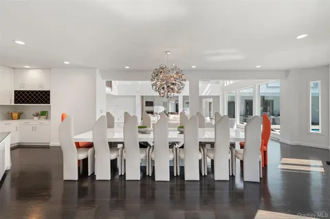 a living room with furniture kitchen view and a large window