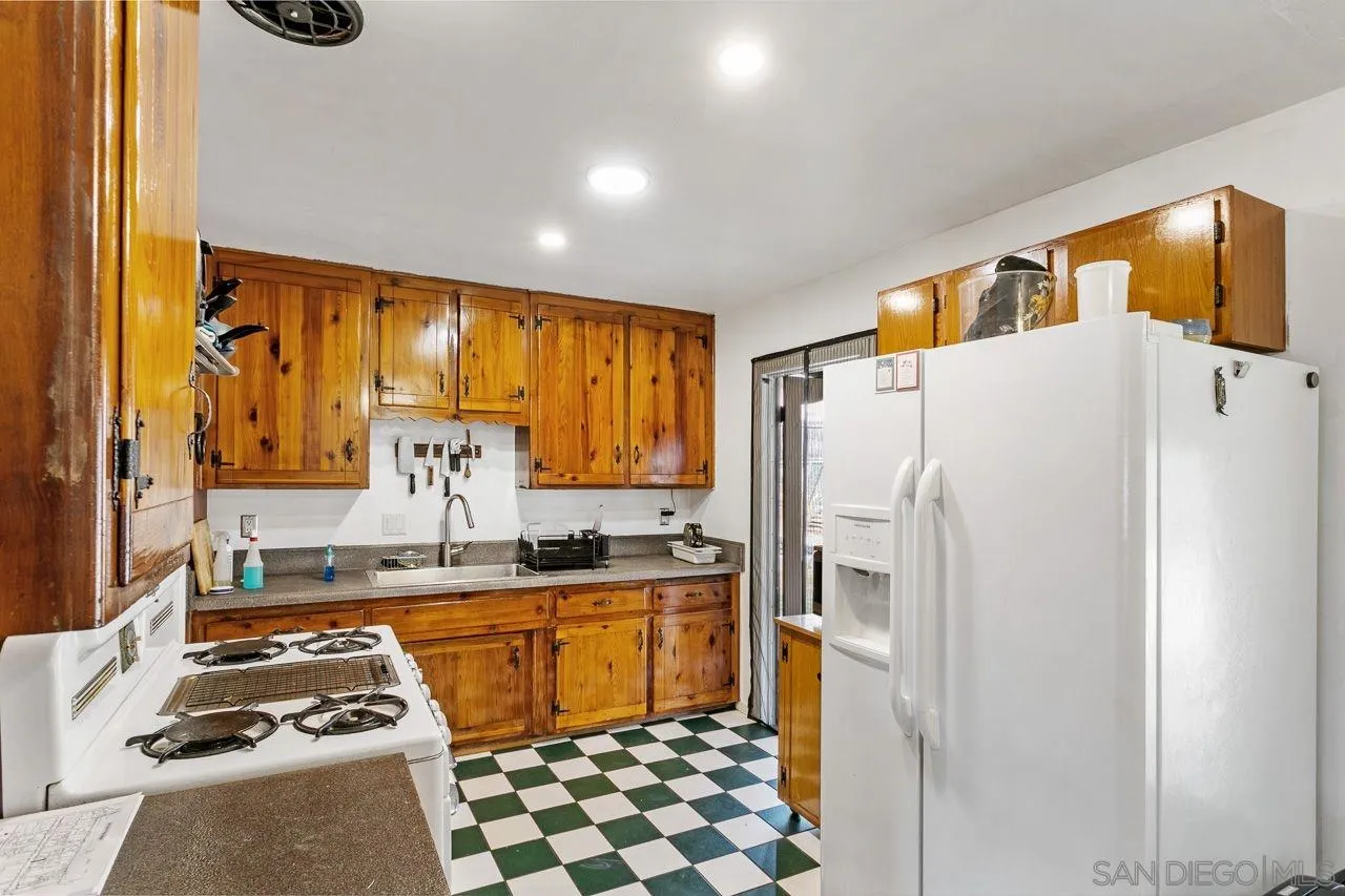 2917 Rosedale Court Spring Valley, CA 91977 - Photo 5 of 10 a kitchen with a refrigerator a stove and a sink