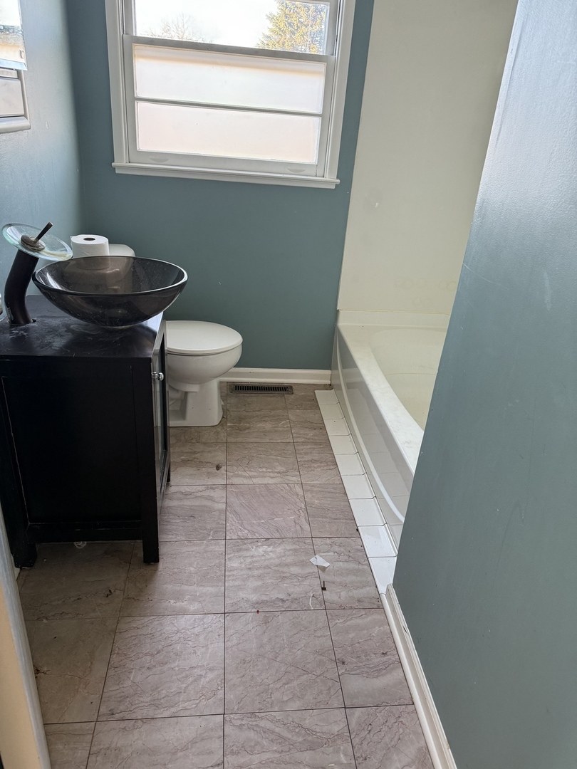 35049 North Edgewater Lane Ingleside, IL 60041 - Photo 7 of 9 a bathroom with a granite countertop toilet and a sink