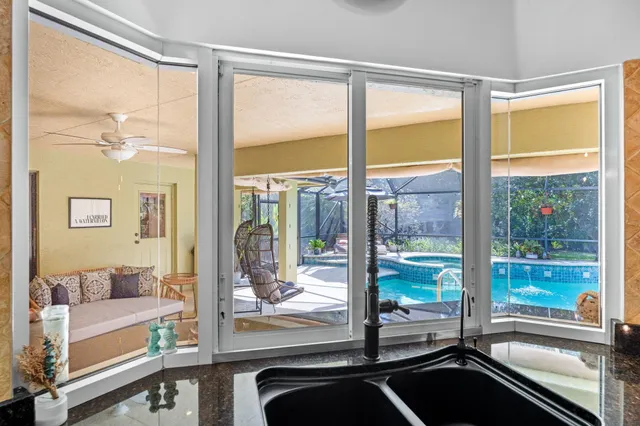 a view of swimming pool with a patio and a yard