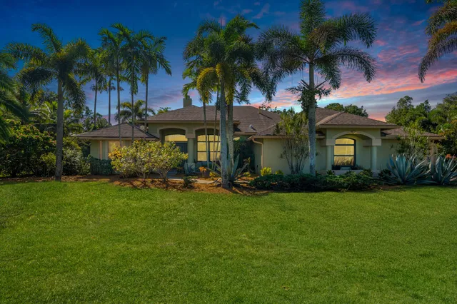 a view of a backyard with table and chairs under an umbrella