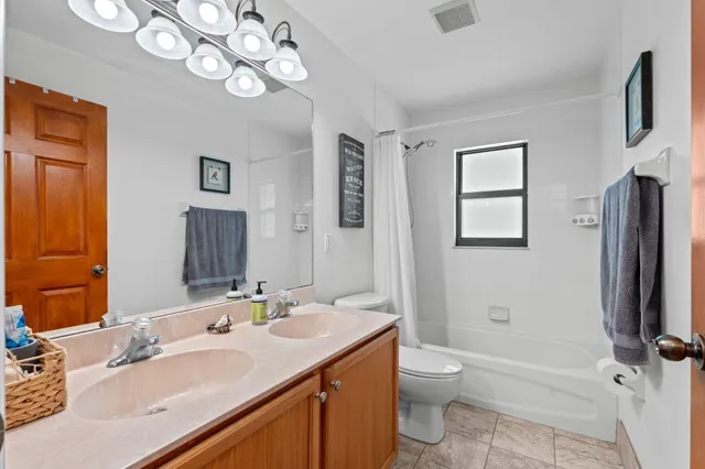 a view of a house in a big yard with palm trees