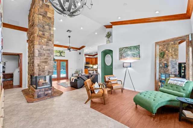 a kitchen with stainless steel appliances granite countertop a stove a sink dishwasher and a refrigerator with wooden cabinets