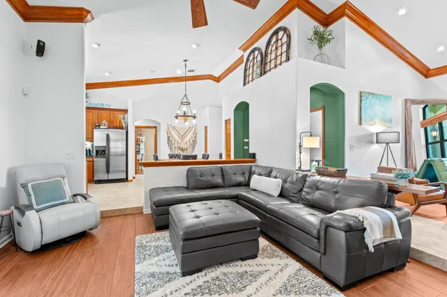 a view of a dining room with furniture and a chandelier