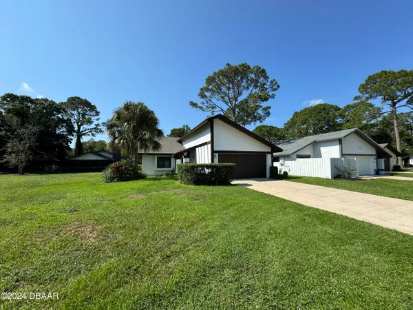 a front view of house with yard and green space