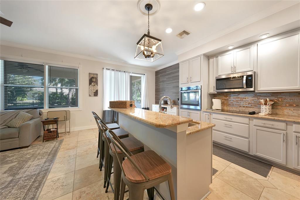 10007 Winding River Road Punta Gorda, FL 33950 - Photo 11 of 44 a kitchen with kitchen island granite countertop a sink and counter space