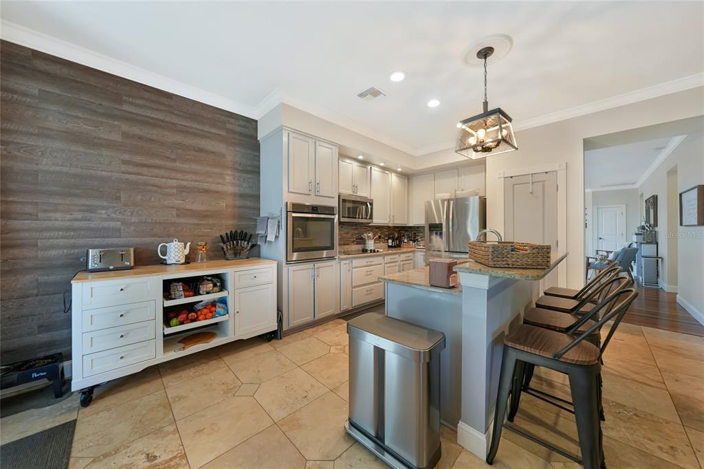 10007 Winding River Road Punta Gorda, FL 33950 - Photo 14 of 44 a kitchen with stainless steel appliances kitchen island granite countertop a stove and cabinets