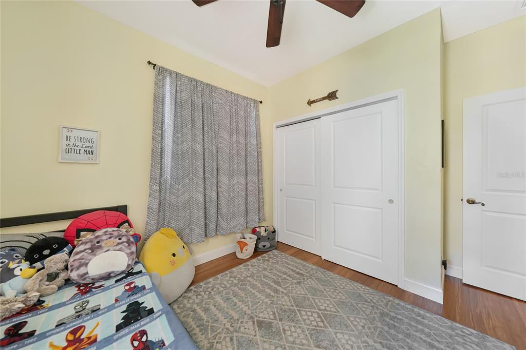 10007 Winding River Road Punta Gorda, FL 33950 - Photo 22 of 44 a view of a bedroom with a bed and wooden floor