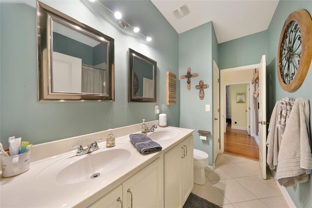 10007 Winding River Road Punta Gorda, FL 33950 - Photo 24 of 44 a en suite bathroom with a double vanity sink and a mirror