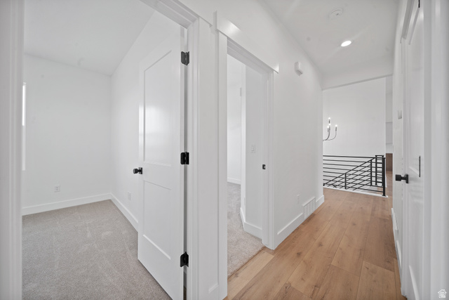1117 East Shilow Road, Unit 106 Erda, UT 84074 - Photo 6 of 21 Hallway featuring wood-finish flooring, recessed lighting, and a modern chandelier