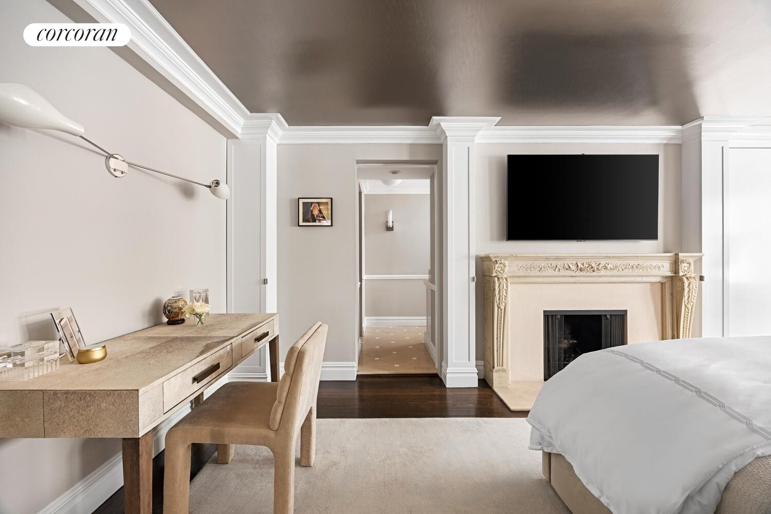 220 East 73rd Street, Unit 6D Manhattan, NY 10021 - Photo 10 of 19 a living room with a fireplace and a flat screen tv