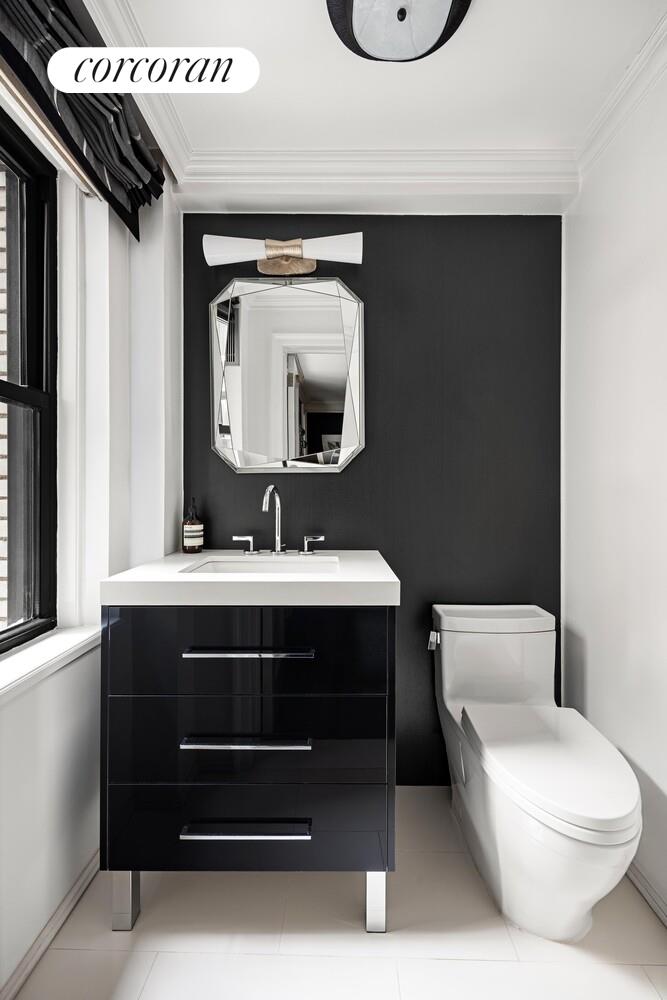 220 East 73rd Street, Unit 6D Manhattan, NY 10021 - Photo 17 of 19 a bathroom with a toilet a sink and mirror