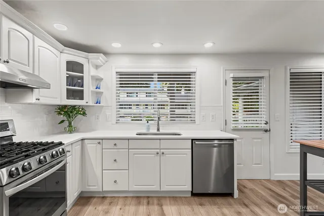 a kitchen that has a sink and a stove