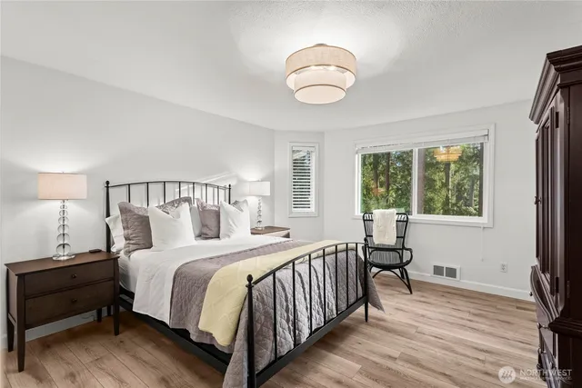 a bedroom with a bed and a large window