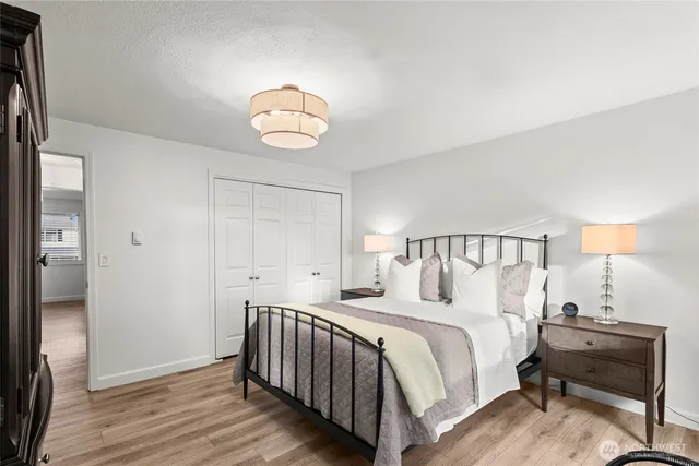 a bedroom with a bed and a chandelier