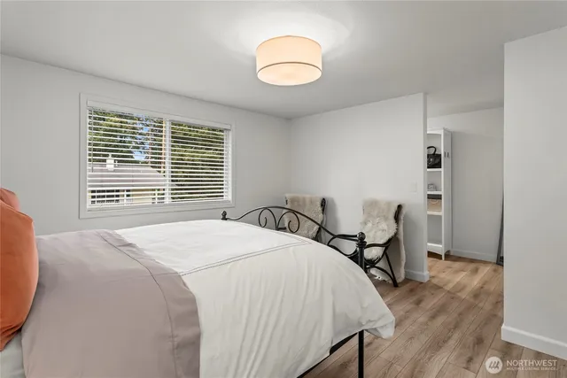 a bed sitting in a bedroom next to a window