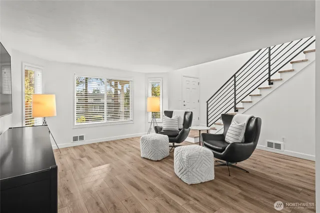a living room with furniture and wooden floor