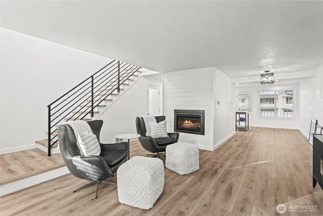 a living room with furniture a fireplace and a wooden floor