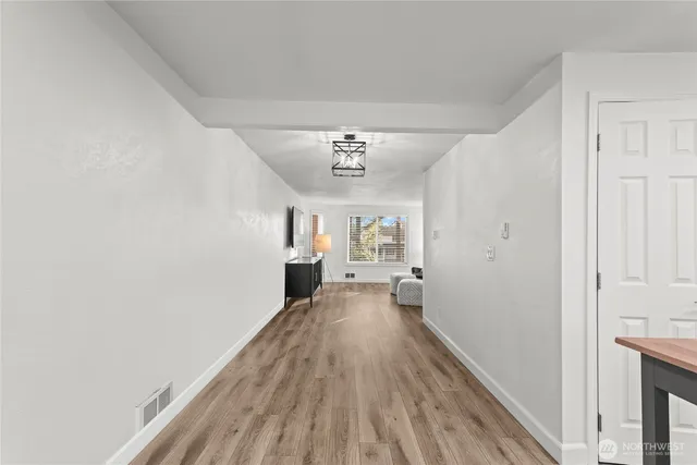 a view of a hallway with a wooden floor