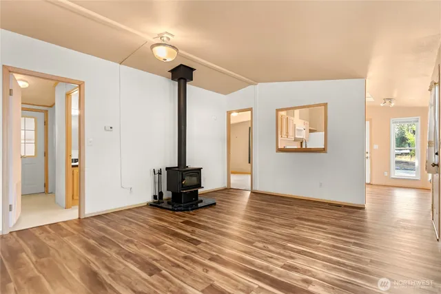 a view of a livingroom with wooden floor and a flat screen tv