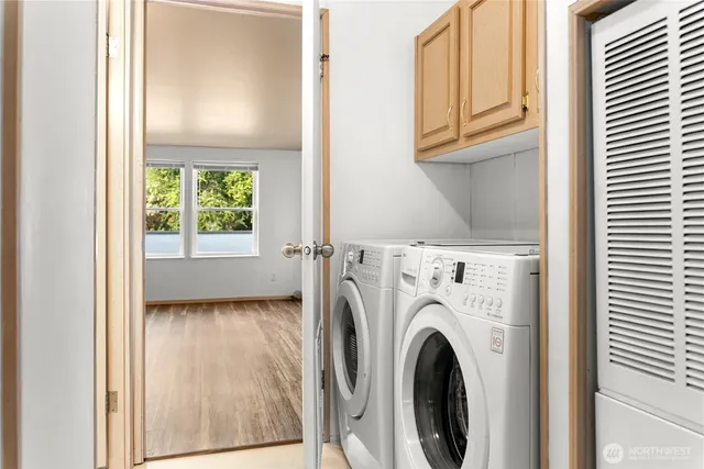 a view of a hallway with washer and dryer