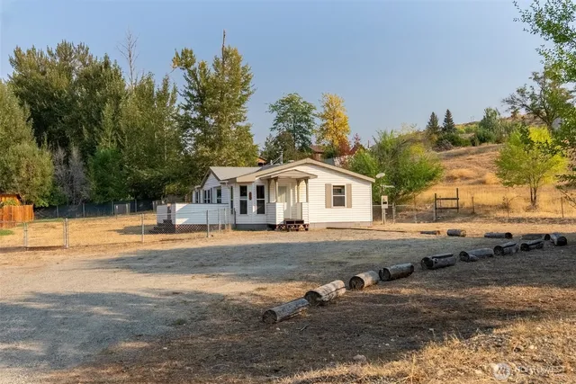 a view of a house with pool and sitting area