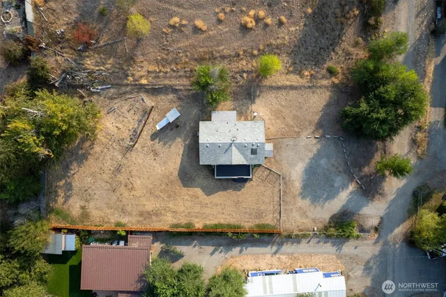 an aerial view of a house with a yard