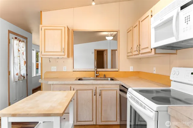 a kitchen with a sink stove and cabinets