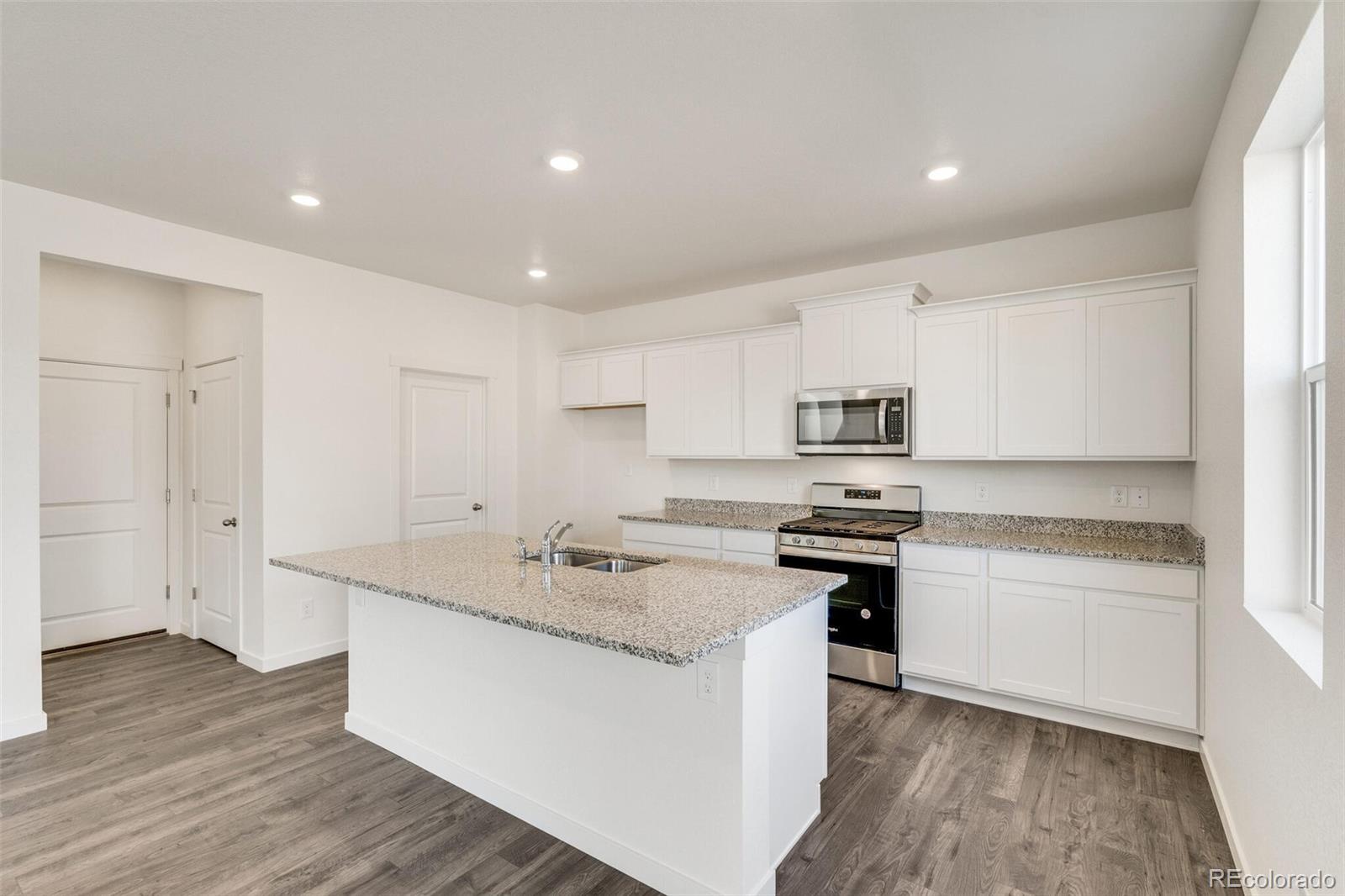 3058 Belleville Ridge Road Elizabeth, CO 80107 - Photo 13 of 31 a kitchen with stainless steel appliances granite countertop a sink stove and refrigerator