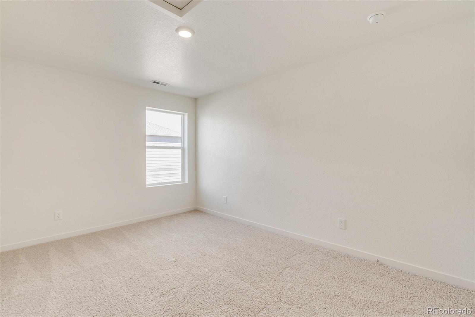 3058 Belleville Ridge Road Elizabeth, CO 80107 - Photo 27 of 31 an empty room with a empty space and windows