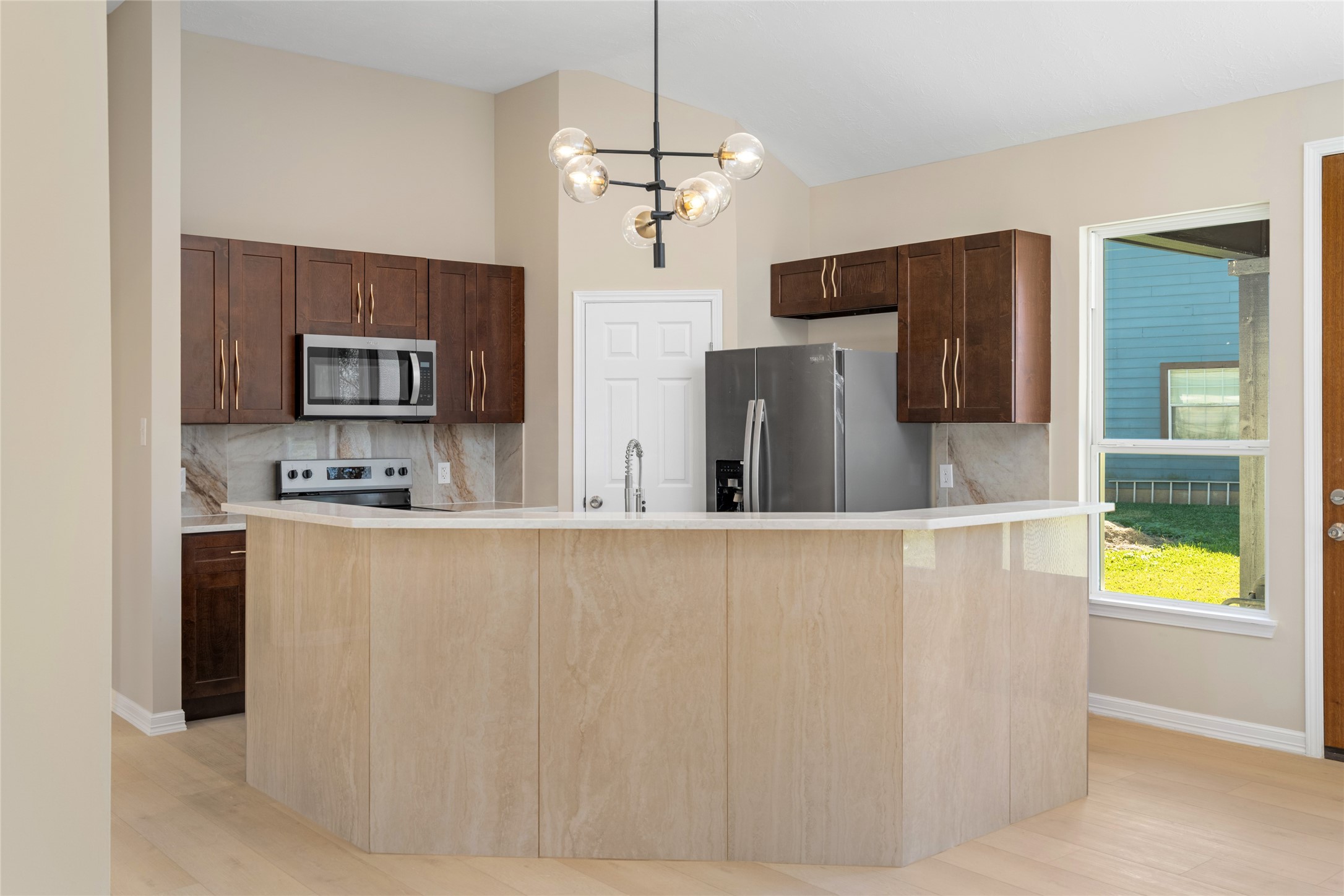 4654 North Teague Street Rosharon, TX 77583 - Photo 17 of 46 The heart of the home shines
with a spacious island,
modern lighting, and
expansive countertops,
perfect for culinary creations
or casual dining.