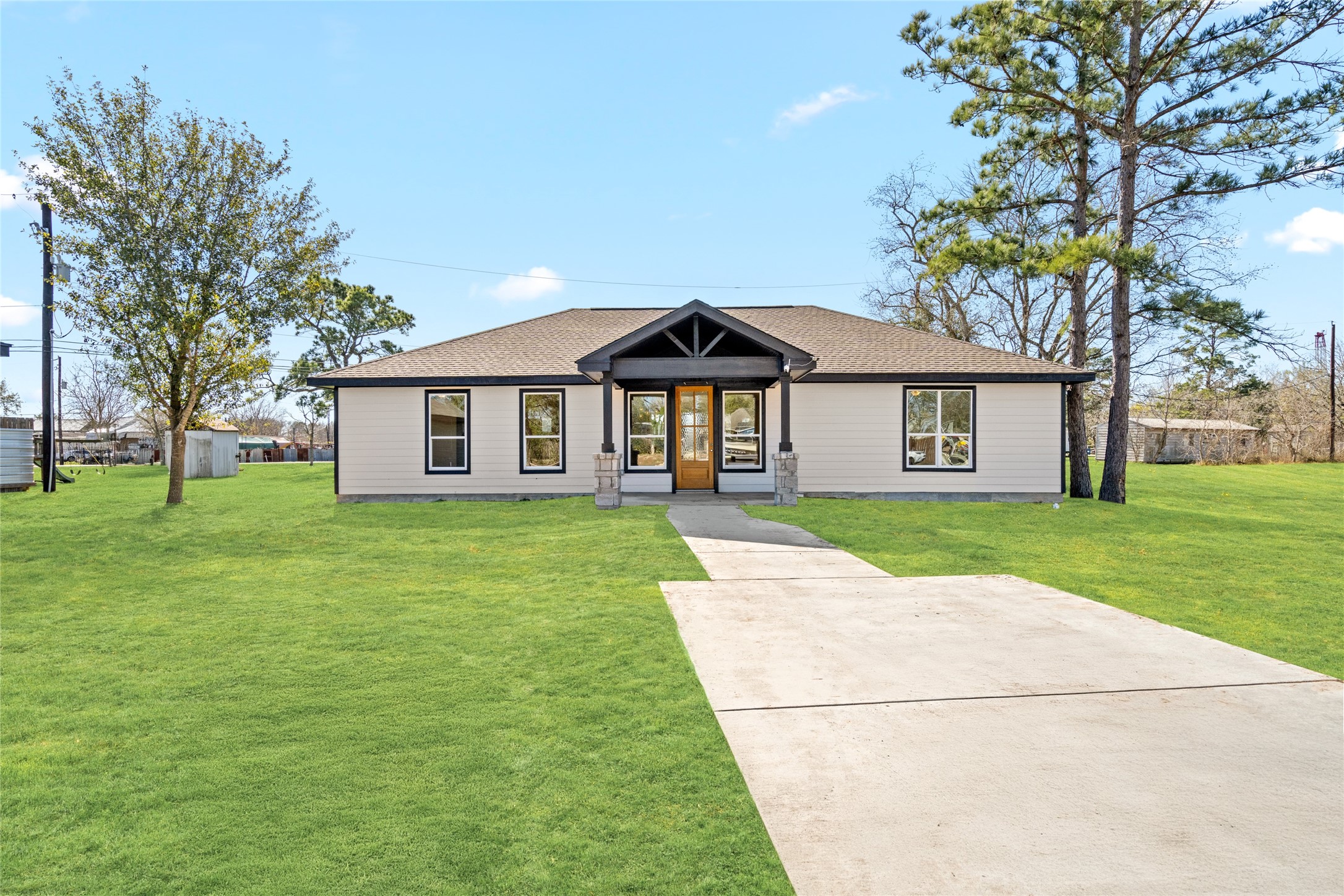 4654 North Teague Street Rosharon, TX 77583 - Photo 2 of 46 Bathed in natural daylight,
this front view showcases the
home’s clean lines,
manicured lawn, and
charming covered porch,
perfect for morning coffee or
evening relaxation.