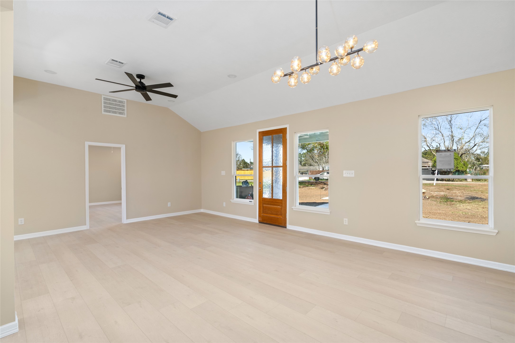 4654 North Teague Street Rosharon, TX 77583 - Photo 25 of 46 Spacious, open-concept living
room with vaulted ceilings,
expansive windows, and a
stylish ceiling fan. This wideangle view showcases
seamless flow and room for
every lifestyle.