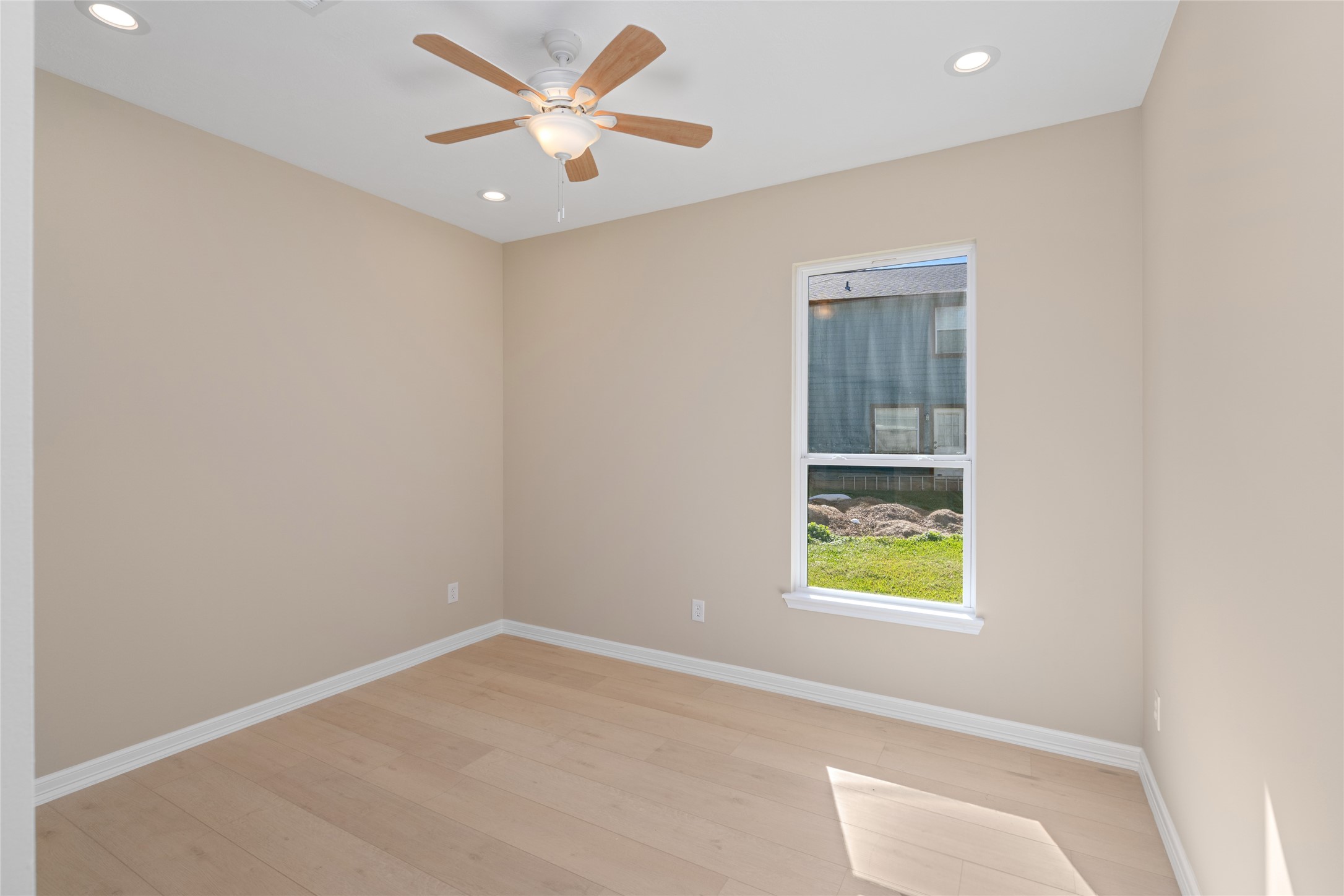 4654 North Teague Street Rosharon, TX 77583 - Photo 39 of 46 Bright secondary bedroom with large window and ceiling fan. Comfort, light, and style combine effortlessly.