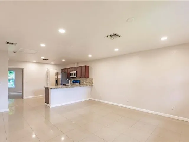 a view of a kitchen with a sink and a microwave