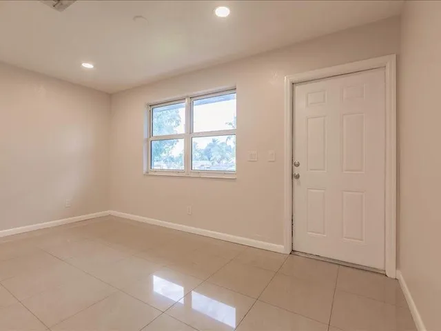 an empty room with windows and closet