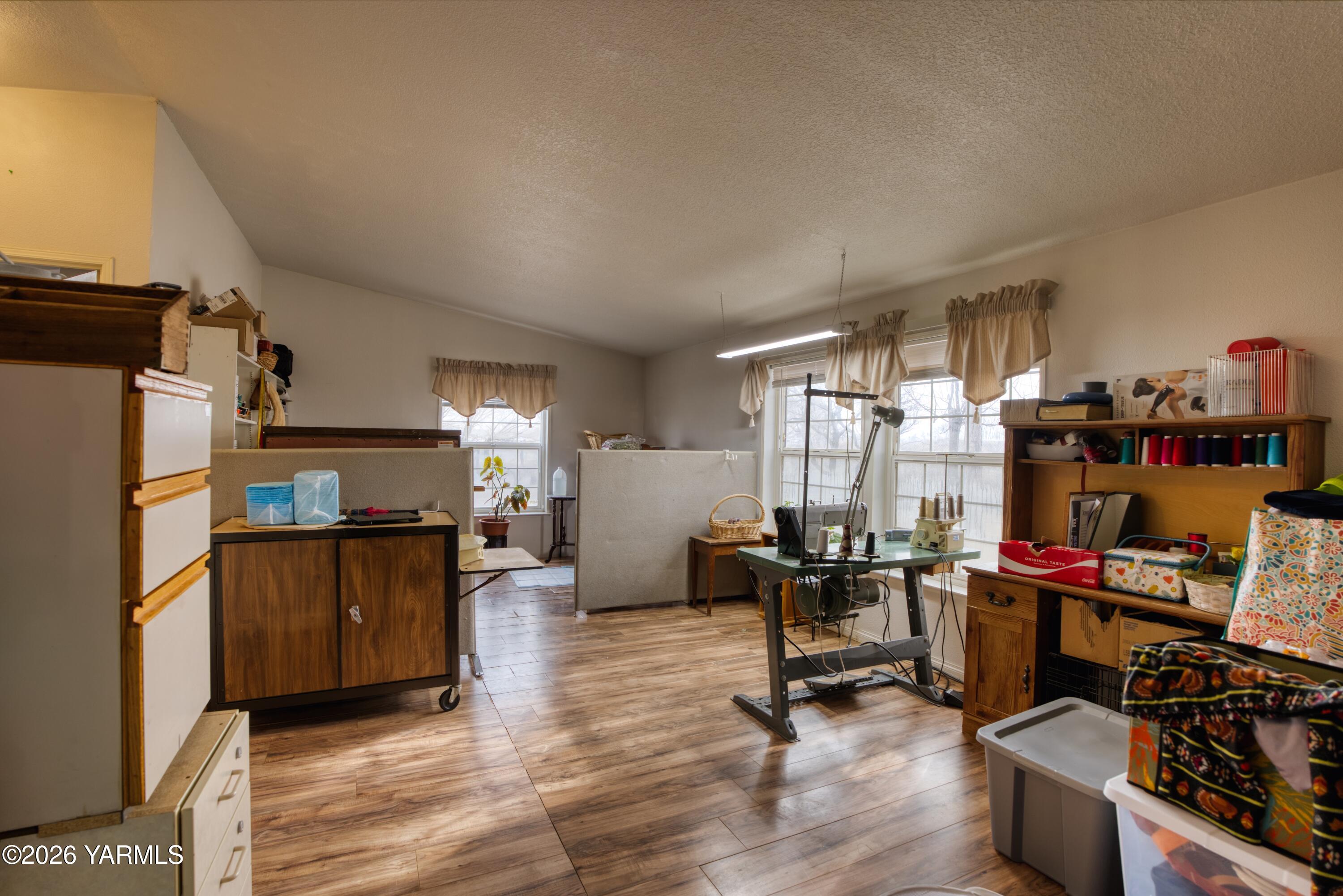 1383 Puterbaugh Road Grandview, WA 98930 - Photo 6 of 19 a view of a workspace with furniture and a window
