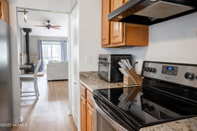 a kitchen that has a table chair and a window