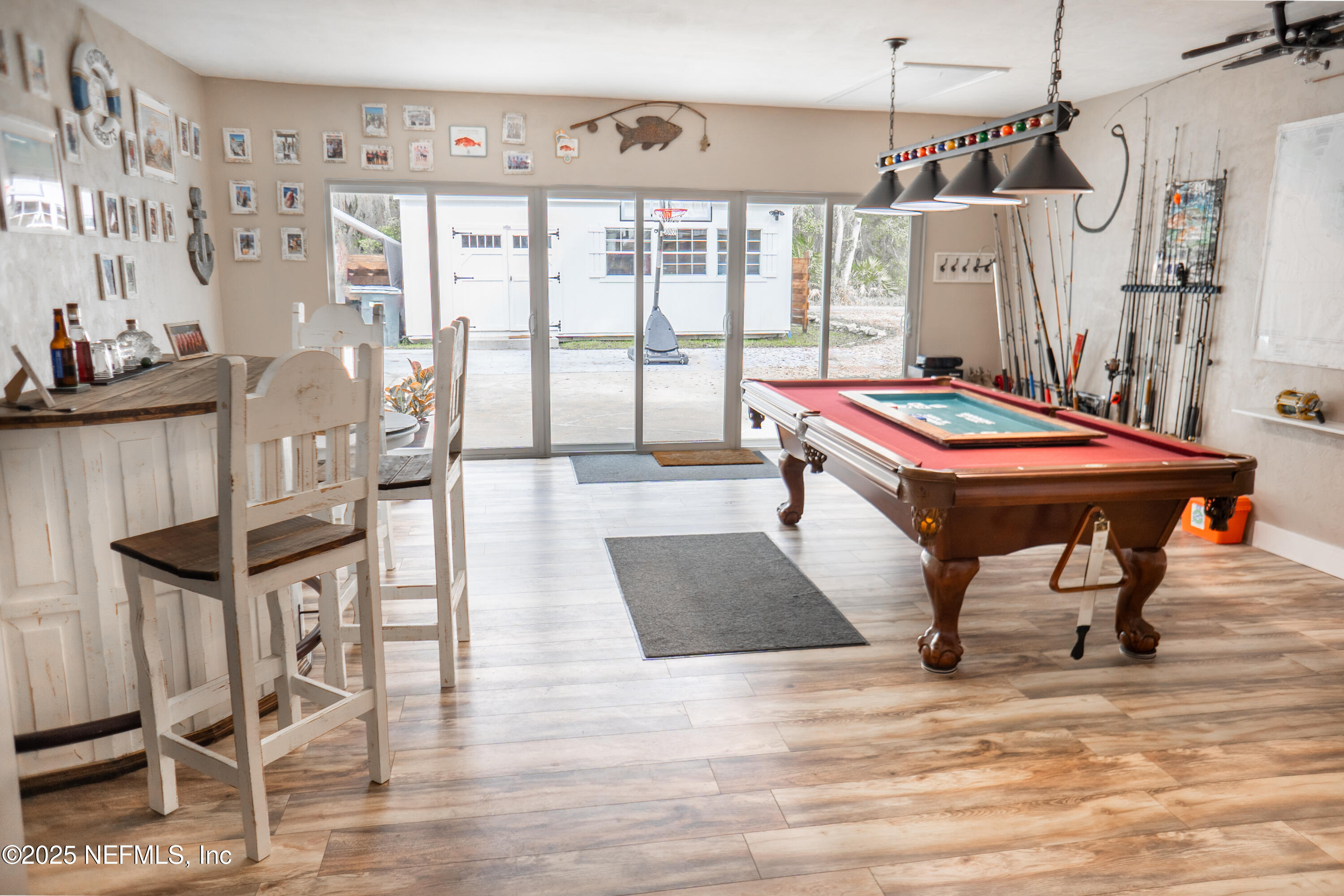 2380 Southeast 43rd Street Keystone Heights, FL 32656 - Photo 33 of 61 a room with wooden floor pool table and chairs