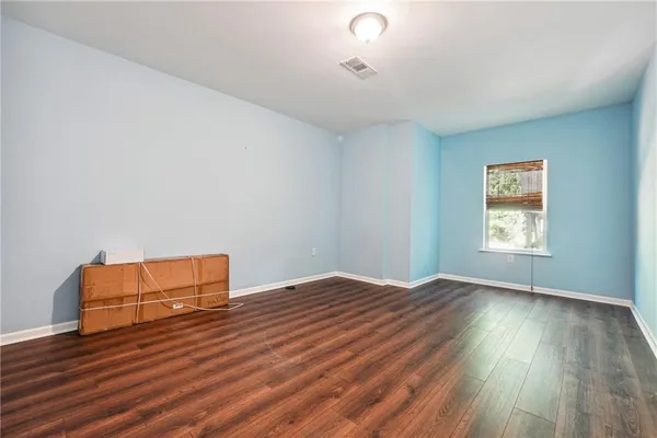 a view of a room with wooden floor and fan