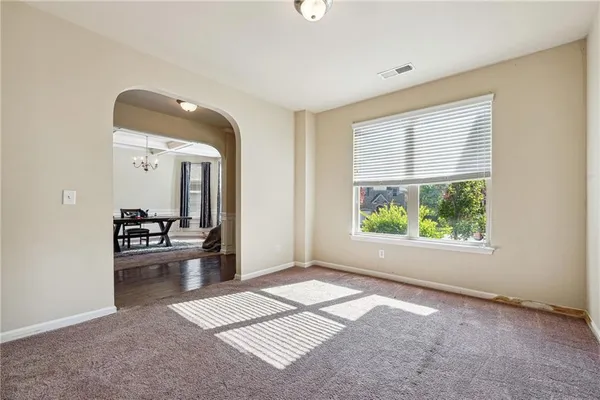 a dining room with furniture and a chandelier