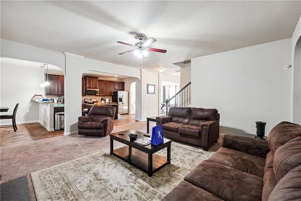 a living room with a couch and a chandelier