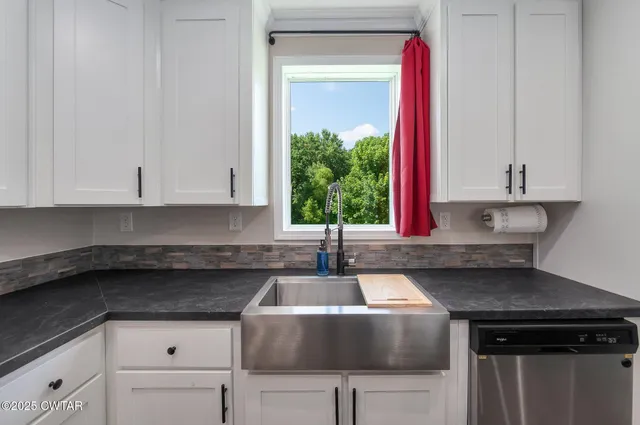 a kitchen with a sink and cabinets