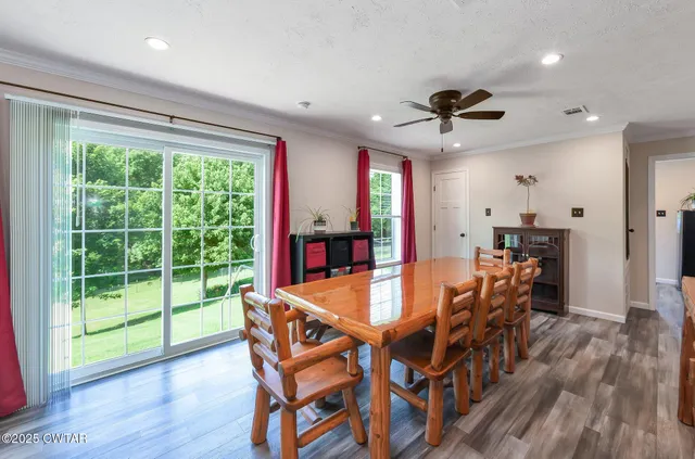 a dining room with furniture window and wooden floor