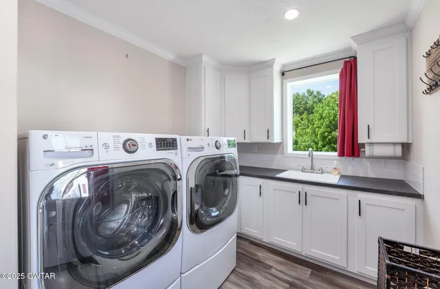 a utility room with sink dryer and washer