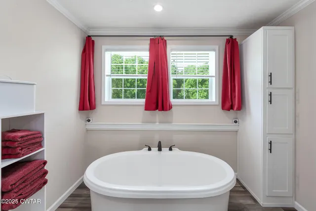 a bathroom with a bathtub and a window