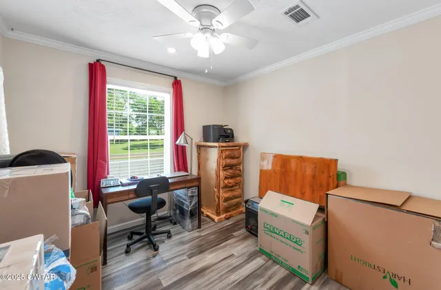 a view of a workspace with furniture and a window